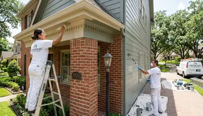 Professional house painters working on residential exterior in Houston, TX